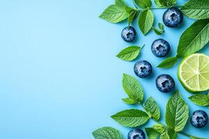 Fresh Blueberries, Mint, and Lime on a Blue Background A Vibrant Summer Food Image. photo