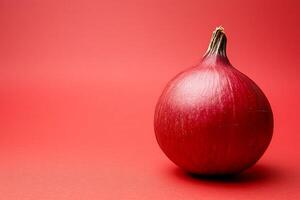 Single Red Onion on Red Background A Vibrant Culinary Still Life. photo