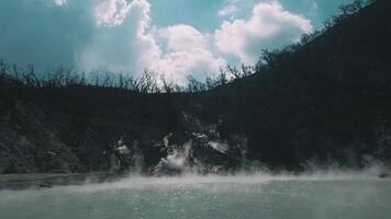 Mystical Steaming Lake in Rugged Mountain Landscape video