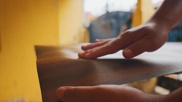 Hands Smoothing a Textured Surface in a Bright Workspace video