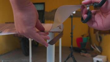 Hands Cutting Material with Scissors in Outdoor Workspace video