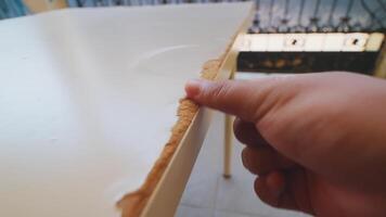 Close-Up of Hand Touching Damaged Table Edge video