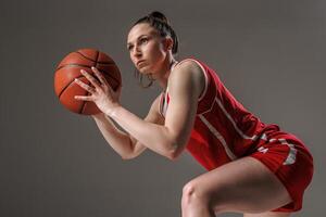 Focused Female Basketball Player in Action, Preparing to Shoot during Professional Training photo