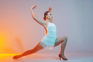 Latin Female Dancer in White Fringe Dress Performing Dynamic Latin Dance Pose in Studio photo