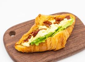 Bacon Egg Salad Croissant Savory Pastry on Wooden Board side view of Breakfast Dessert photo