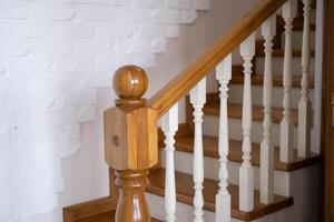 A wooden staircase with a railing will lead to the top photo