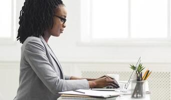 Office Work. Black Girl Using Laptop Computer At Workplace. Copy Space, Side View photo