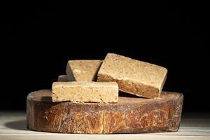 Wooden cutting board with sweets made from peanuts known in brazil as pacoca. photo