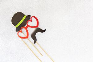 Fun and playful photo booth props with hearts and a hat for festive celebrations