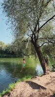 Enjoying the exhilarating summer fun of swinging by the refreshing water video