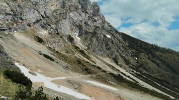 Hikers explore the rocky landscape and scenic views in a mountain region during springtime video