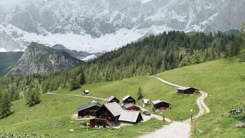 Scenic mountain village located in the Alps with traditional chalets and stunning views of the snowy peaks video