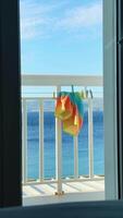 Vibrant beach towels drying on a balcony with a stunning view of the Croatian coastline video