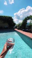 Relaxing by the pool with a refreshing drink, enjoying beautiful views video