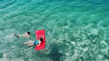 Kids enjoying a sunny day at the beach in Croatia with colorful floaties and clear blue water video
