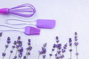 Purple kitchen tools with fresh lavender on a light background create a charming culinary setting photo