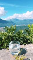 Refreshing and Invigorating Glass of Cool Water Surrounded by Mountain View video