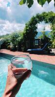 Enjoy a Refreshing Poolside Escape with a Cool Glass in Hand to Relax and Unwind video