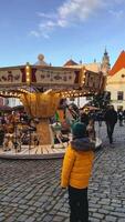 Charming and Colorful Carousel at the Winter Market Featuring a Child video