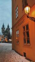 A winter scene in Prague features a cozy restaurant covered in a blanket of snow video