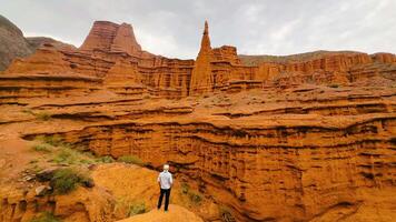 Majestic Red Rock Formation featuring a Hiker amidst a Scenic Canyon Landscape video
