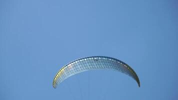 Paraglider Sky Flight - A single paraglider soars through the bright blue sky. video
