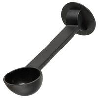 Black plastic measuring spoon for ground coffee, designed for coffee machine, with long handle and round base, isolated on background. photo