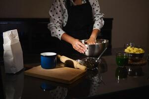 Home Chef Preparing Dough for Dumplings in a Cozy Kitchen Setting photo
