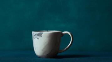 Steaming Latte in Marble Mug on Teal Background photo