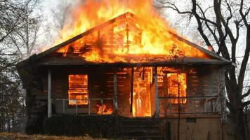 a house is on fire with flames coming out of the front door video