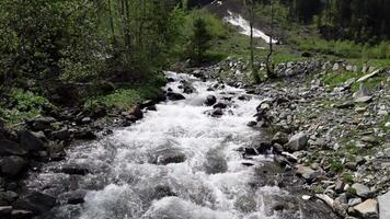 a stream of water flowing through a rocky mountain side video