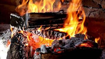 a fire burning in a fireplace with wood and wood video