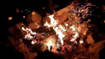 a fire is burning in the dark with sparks flying video