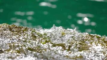water flowing over rocks and green water video