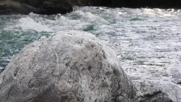 a large rock in the middle of a river video
