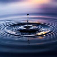 A Frozen Instant of a Water Droplet Hitting Water photo