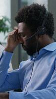 Frustrated multiethnic operators callcenter business crisis computer headache Caucasian African men depressed sad agent headset failure service bad call center Hispanic woman helpline support office video