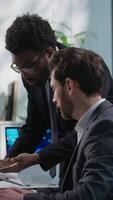 Annoyed African American leader dissatisfied boss scolding arguing Caucasian office worker businessman wrong failed project computer business men males problem conflict director swear employee mistake video