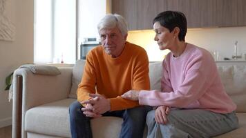 Worried wife consoling hugging upset husband. Pensive distressed senior man struggles stress burnout video