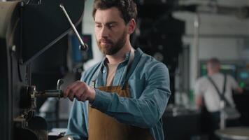 Caucasian man barista work with roaster machine on factory coffee roasting fresh beans smelling aroma technologist check quality caffeine product male business owner enjoy smell natural roasted grains video