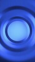 Stylish abstract background with dynamic smooth gradient circles and textured lines in vibrant blue. Copy space for logo or text. This versatile vertical background is full HD and a seamless loop. video