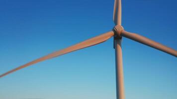 An aerial view of a windmill against the blue sky during sunset on a beautiful summer evening. video