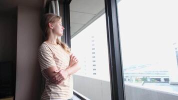 woman on vacation, opening curtains on the window in the morning and happily looking away enjoying the view video
