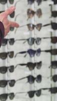 Man shaking hands with optometrist in trendy eyewear store video