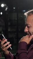 Cheerful men toasting with drinks and smiling at the camera in a lively bar video
