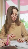 Three lovely teen girls collaborating on a school project in a bright classroom video
