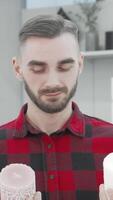 Thoughtful man savoring aromatic candles in a chic home goods store video