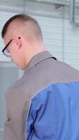 Skilled mechanic closes car hood at the service station video