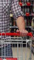 Man expertly navigating a vibrant supermarket aisle with a shopping cart video