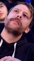 Thoughtful man savoring popcorn in a cozy cinema video